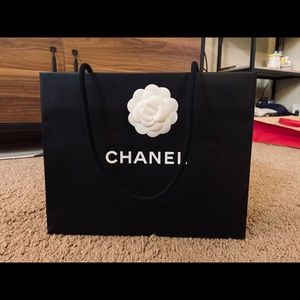 One large Chanel camellia flower paper bag